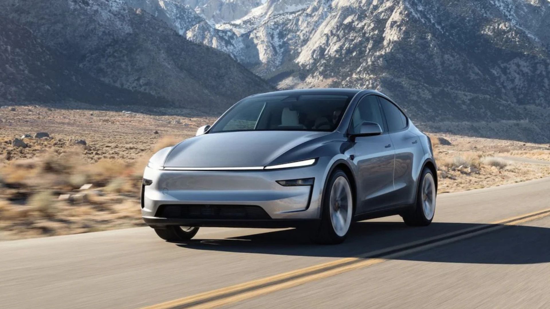 Tesla Model Y driving on highway in India, representing Tesla India sales drop 2025